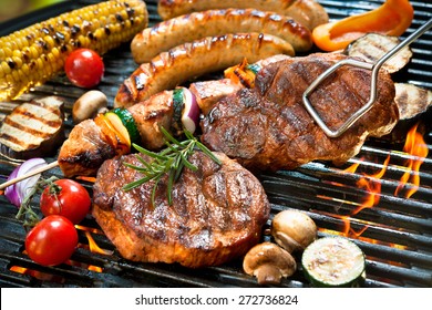 Assorted delicious grilled meat with vegetables over the coals on barbecue