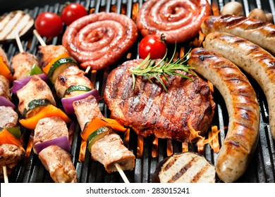 Assorted delicious grilled meat with vegetables over the coals on barbecue - Shutterstock ID 283015241
