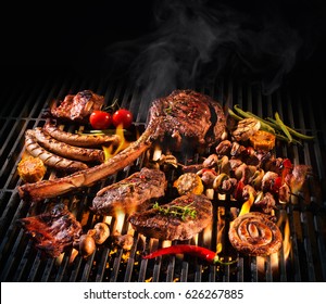 Assorted delicious grilled meat with vegetables over the coals on a barbecue - Shutterstock ID 626267885