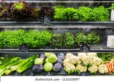 Assorted Different Kinds Of Fresh Organic Green Vegetables On Display In A French Supermarket.  Background With Cauliflower; Cabbage; Lettuce. Healthy Vegetarian Food Concept. Paris, France 