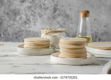 assorted different types of dough. dough for dumplings, dumplings, pasties, noodles and lasagna sheets on a white wooden background  - Shutterstock ID 2174735201