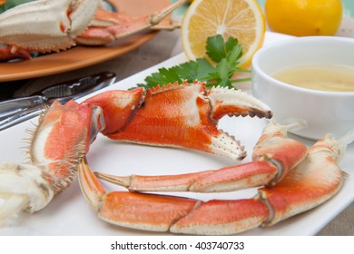 Assorted Dungeness Crab Legs With Butter Mustard Sauce And Fresh Lemons.
