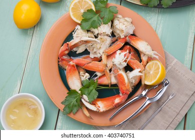 Assorted Dungeness Crab Legs With Butter Mustard Sauce And Fresh Lemons.
