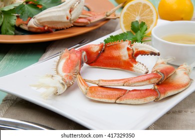 Assorted Dungeness Crab Legs With Butter Mustard Sauce And Fresh Lemons.
