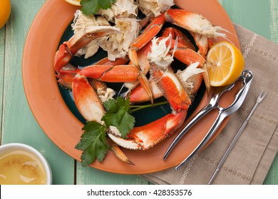 Assorted Dungeness Crab Legs With Butter Mustard Sauce And Fresh Lemons.
