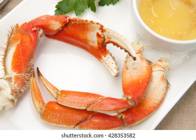 Assorted Dungeness Crab Legs With Butter Mustard Sauce And Fresh Lemons.
