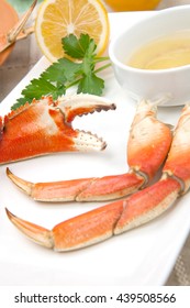 Assorted Dungeness Crab Legs With Butter Mustard Sauce And Fresh Lemons.
