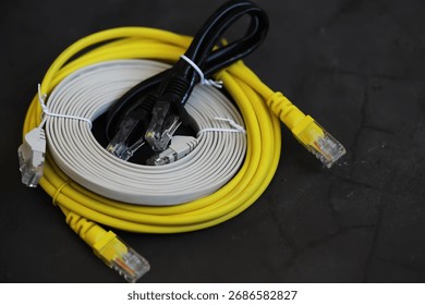 Assorted Ethernet Cables on Dark Surface for Network Connectivity Solutions