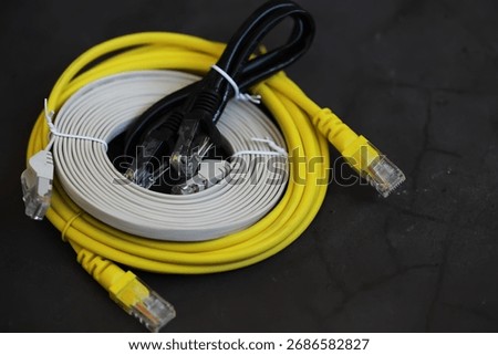 Assorted Ethernet Cables on Dark Surface for Network Connectivity Solutions
