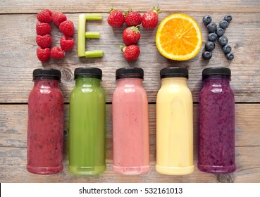 Assorted flavoured smoothie juices in bottles with detox spelt using fruits and vegetables 