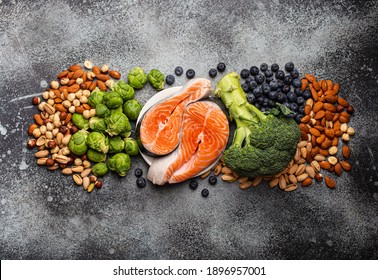 Assorted Food For Brain Health And Good Memory: Fresh Salmon, Vegetables, Nuts, Berries On Stone Background. Healthy Fresh Products To Boost Brain Power, Top View 
