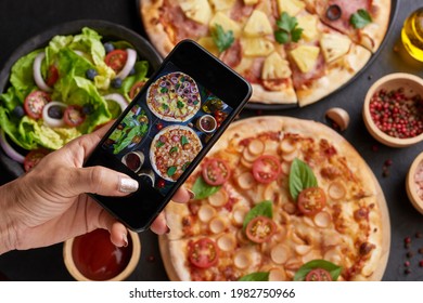 assorted food set on table. Italian pizza and pizza cooking ingredients on dark stone background. mozzarella, black olives, herbs and spices, take photo of pizza by smartphone. top view. - Powered by Shutterstock