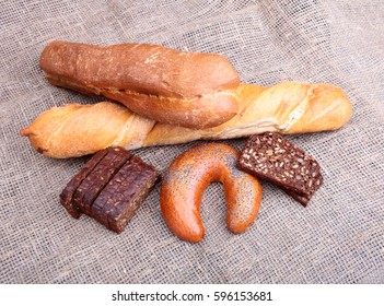 Assorted fresh breads isolated on old sackcloth.