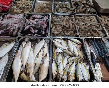 Assorted Fresh Fish, Squid, And Prawns Sold In The Traditional Market