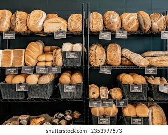 Assorted freshly baked bread types displayed on the store racks
