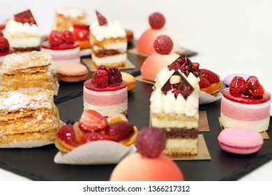 Assorted fruit cakes for holiday. Desserts with fruits, mousse, biscuits - Powered by Shutterstock