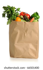 Assorted fruits and vegetables in brown grocery bag isolated over white background