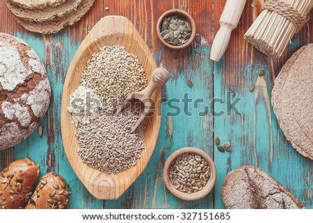 Assorted grains and bread. Preparing food concept, country  style . Bread full rich grains and natural ingredients.  Top view, vintage toned 