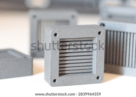 Assorted gray 3D printed prototype parts made with SLS technology