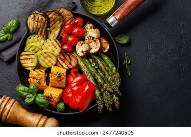 Assorted grilled vegetables on a frying pan, showcasing a colorful and healthy meal. Flat lay with copy space - Powered by Shutterstock