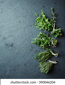 Assorted herbs on a stone background. Marjoram, thyme, lemon thyme, oragno. Flat lay