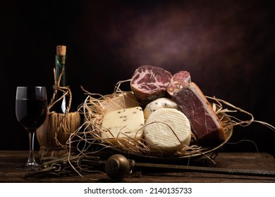 Assorted homemade cheese, salumi on wooden table with a wooden background. Close up - Shutterstock ID 2140135733