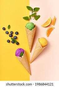Assorted of ice cream in cones on white background. Colorful set of ice cream of different flavours. Ice cream isolated with nuts, fruits and berries. Poster for interior.