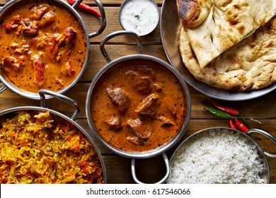 assorted indian curry and rice dishes shot from overhead composition