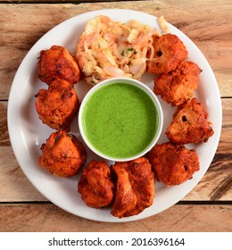 Assorted indian food Chicken Tikka kebab served on rustic wooden background. Dishes and appetizers of indian cuisine, selective focus