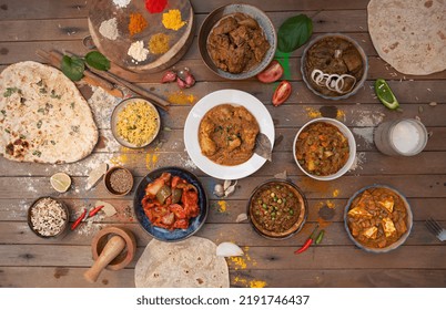 Assorted Indian food, Rice with Saffron, Egg Briyani,Plain Naan, spice, Chicken Channa Curry, Mutton Briyani, Veg Makhani, Curry butter chicken, Palak Paneer, Biryani, Vegetable Curry, Papad, Jeera Al - Shutterstock ID 2191746437