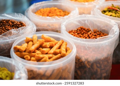 Assorted Indian snacks in plastic containers