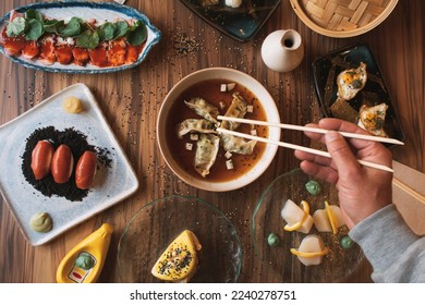 Assorted Japanese food. Famous dishes of Asian cuisine on the table. Top view. The concept of a Japanese restaurant. Asian style banquet - Powered by Shutterstock