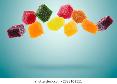 assorted jelly candies floating on blue background.