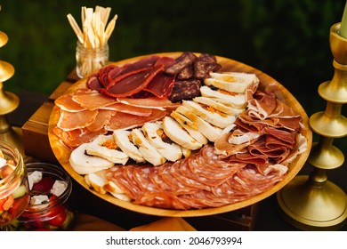 Assorted Meat Cuts. Sausage, Meatloaf, Ham On A Round Wooden Plate. Snack For The Festive Table