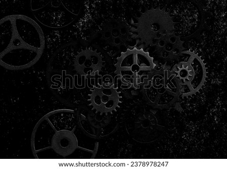 Assorted mechanical grunge gears on gritty black background