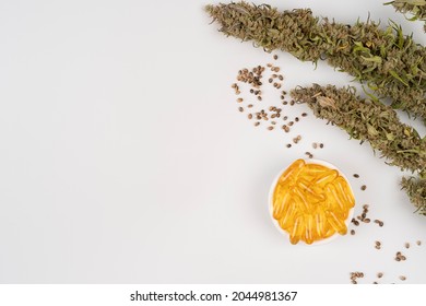 Assorted medical cannabis products with bud and CBD oil capsules isolated over white background with copy space for text