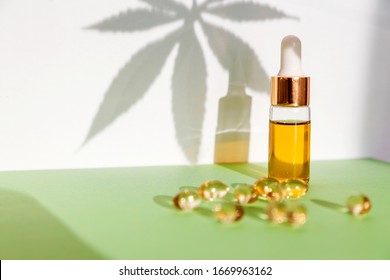 Assorted Medical Cannabis Products With Capsules And CBD Oil Isolated Over White And Green Background . 