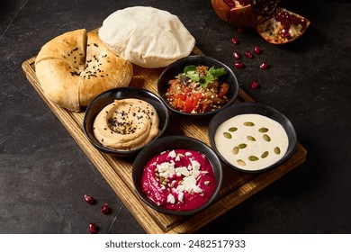 Assorted Middle Eastern Dips with Pita and Flatbread - Hummus, Beetroot Hummus, Ajapsandali, and Tonnato Sauce.