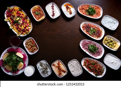 Assorted Middle Eastern dishes set and mezes background. Empty in the middle of the photo. Turkish and Arabic kitchen foods top view photo.