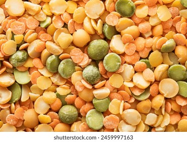 Assorted mix of dry healthy orange and green peas seeds textured background.