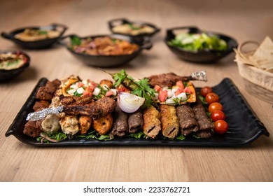 Assorted mix grills with tikka boti seekh kabab of chicken, beef, lamb, mutton bbq platter served in dish isolated on table top view of arabian food - Shutterstock ID 2233762721