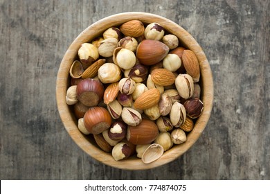 Assorted Mixed Nuts In Bowl On Wooden Table. Top View