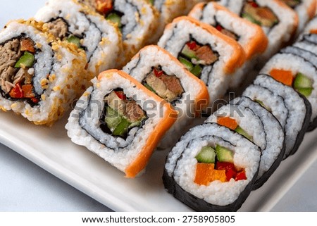 Assorted Mixed Sushi Platter with Salmon Maki California Rolls and Sesame Rolls