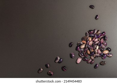 Assorted multicolored beans scattered on black stone background. Raw healthy ingredient for cooking useful food, top view - Shutterstock ID 2149454483