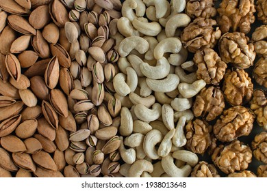 Assorted nuts almonds, pistachio, cashews, walnut. Flatly organic mixed nuts background. Healthy food, useful microelements and vitamins. Useful health snack.Vegetarian snack of different nuts - Shutterstock ID 1938013648