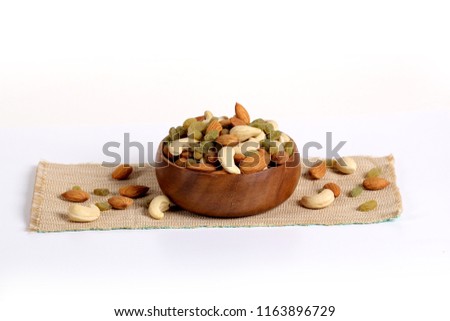 Assorted nuts on white, dry fruits, mix nuts, almond, cashew, raisins