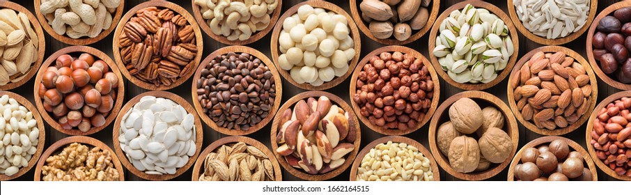 assorted nuts and seeds in wooden bowls, healthy food background.