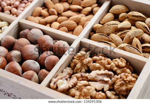 Assorted nuts in wooden box - walnut, almond,\
hazelnut, cashew and\
peanuts