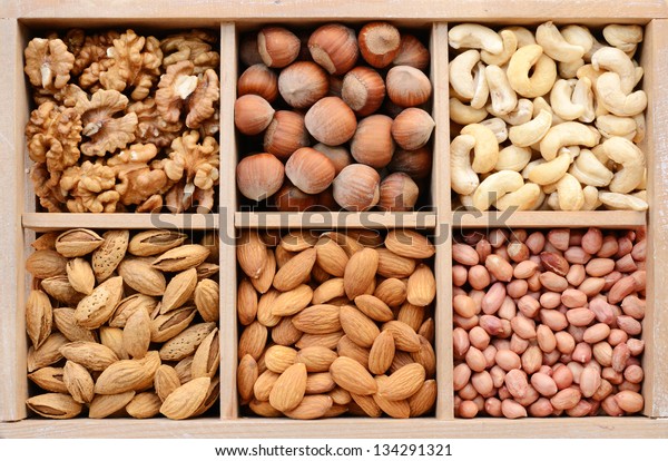 Assorted nuts in wooden box - walnut, almond,\
hazelnut, cashew and\
peanuts