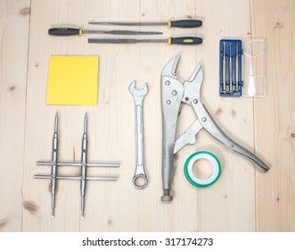 Assorted objects tool on wood.